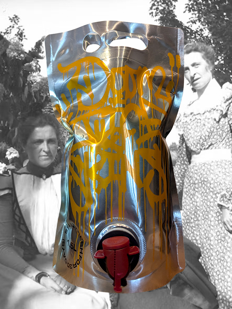 A bottle of Doom Juice 'Skins' Goon Bag 2024 (1.5L) from Riverland, SA - In an empty carpark an old woman pushes a trolly full of broken suitcases. The wheels squeak as a dog barks in the distance.