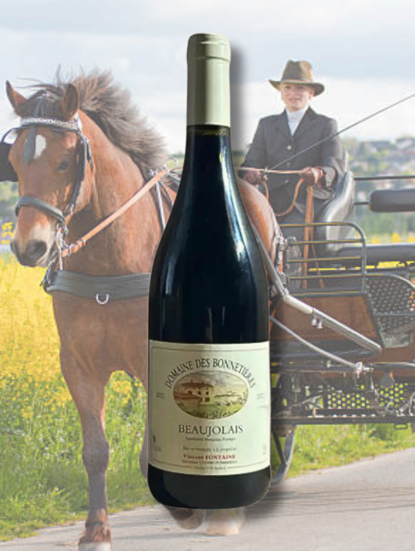 Domaine des Bonnetières Beaujolais 2023 bottle in front of a horse and carriage scene with a rider in formal attire. Light-bodied, organic Gamay from Beaujolais, France.