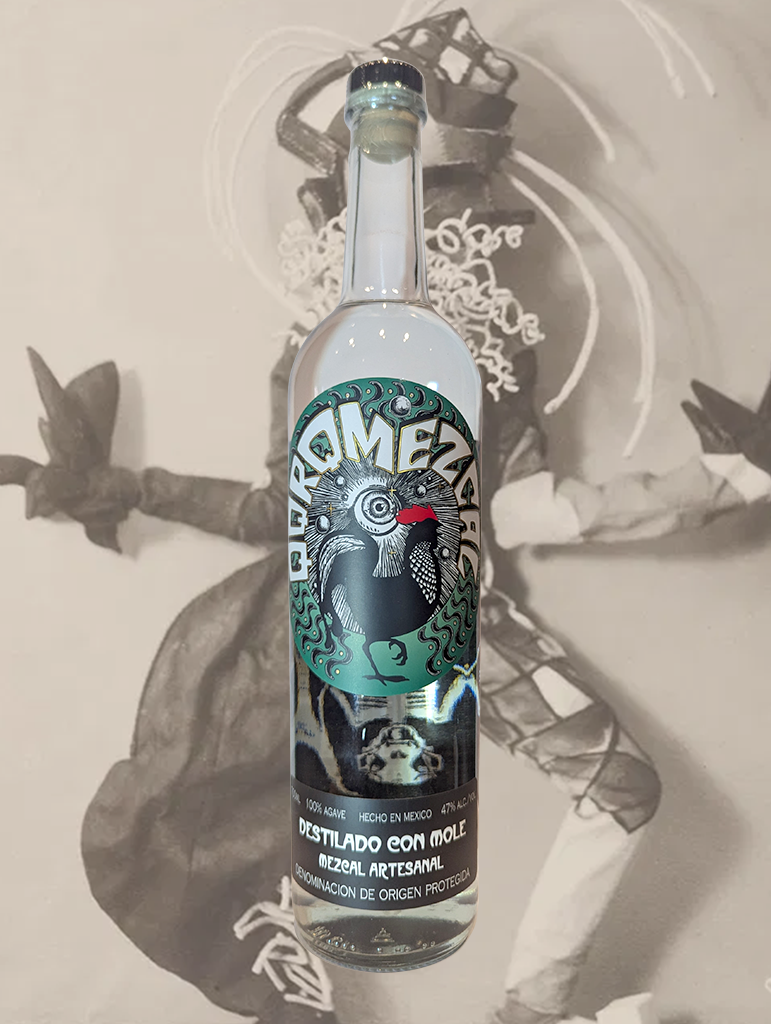A bottle of Quiquiriqui 'Destilado Con Mole' Mezcal from Oaxaca, Mexico - The scent of the old mango grove lingers in the air of the Red Ant Rive that flows through the village of the San Luis del Rio, offering a signature note to this expression. 