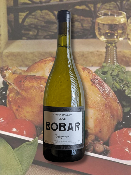 Bottle of Bobar Wines 2023 Viognier on a background of a vintage cookbook picture for roast chicken. 