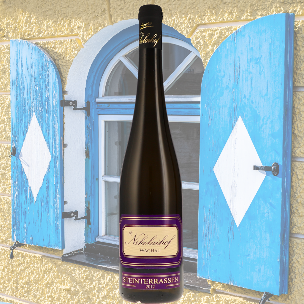 Bottle of Nikolaihof 'Steinterrassen' Grüner Veltliner 2012 in front of a rustic Austrian-style window with blue and white shutters.